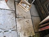 a pile of junk sitting on the floor next to a stove