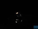 dark photo of a car in the dark with its headlights on