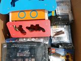 a cardboard box filled with assorted toys and games