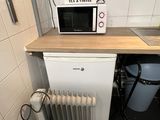 an image of a kitchen with a microwave and a radiator