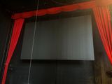 a large screen hanging from the ceiling in a room