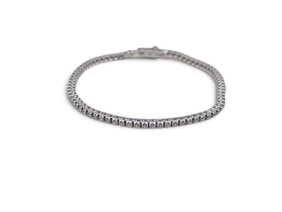 a close up of a silver bracelet with a diamond on it
