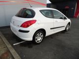 the back of a white car parked in a parking lot