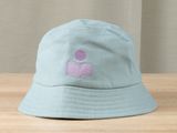 a blue hat with a pink logo on it sitting on a table