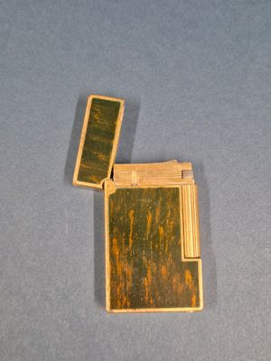 a lighter that is sitting on a blue surface