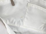 a close up of a white bag with a zipper on it