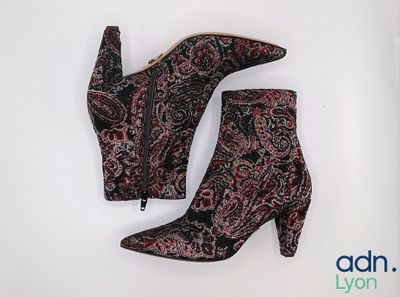 une paire de bottes pour femme ornées d'un motif paisley sur fond blanc
