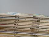 several children ' s books stacked on top of each other on a table