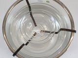 a glass bowl with a spoon in it on a table