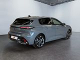 the rear end of a grey car in a showroom