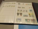 an open book with stamps on it sitting on a table