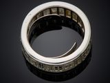 a close up of a diamond ring on a black surface