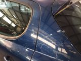 a blue car that is parked in a garage