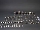 a lot of silver spoons and spoons on the table