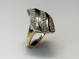a close up of a gold ring with diamonds on a white surface