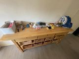 a wooden table with baskets on top of it in a room