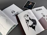 an open book with a drawing of a woman and a picture of a man