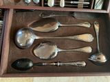 several spoons and spoon spoons are in a wooden box