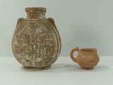 un petit vase et une petite tasse posés sur une table