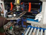 a machine that is working on pipes in a factory