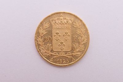 gros plan d'une pièce d'or sur une surface blanche