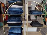 a rack with jeans on it in a clothing store