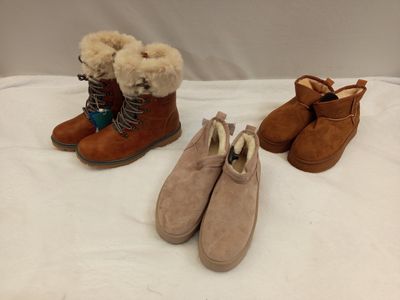 three pairs of women ' s shoes are lined up on a bed