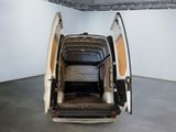a white van with its doors open in a room