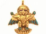 un gros plan d'un pendentif en or sur lequel figure un oiseau, vu de la tête