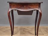 an old wooden table with a drawer on top of it