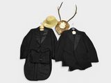 two suits and a hat are hanging on a wall