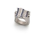 a close up of a ring on a white surface with blue and white stones