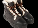 a close up of a pair of black boots with brown laces