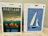 two bags that have a picture of a sailboat on them