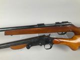 a couple of guns sitting next to each other on top of a table