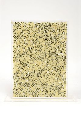a close up of a piece of art on a white surface