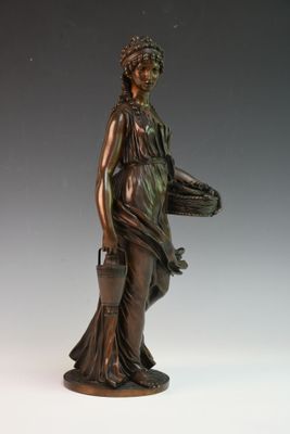 statue en bronze représentant une femme tenant un panier et une sacoche