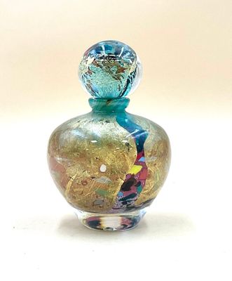 a small glass bottle with a colorful design on it