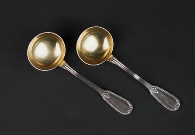 a pair of silver spoons on a black background