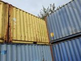 many containers stacked on top of each other on the ground