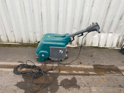 a green and black machine that is sitting on the side of the street