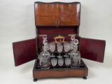 a wooden case with a set of wine glasses in it