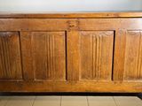 an old wooden chest sitting on top of a tiled floor