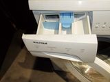 a white washer with a blue handle in a room
