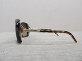 sunglasses on a table with a white cloth and a white background