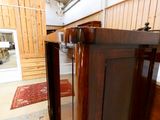 a wooden cabinet with a door open in a room