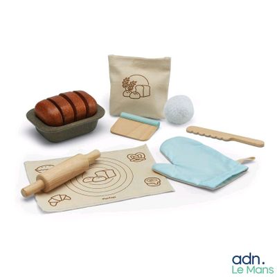 a wooden play set with bread, doughnuts, and a rolling pin