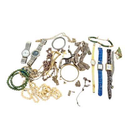 a pile of assorted jewelry on a white surface