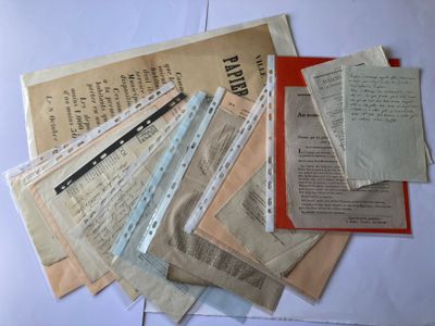 a pile of old newspapers sitting on top of a table