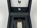 an open box with a watch inside of it on a white surface
